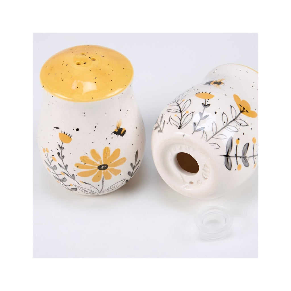 Salt & Pepper Set - features bees buzzing over flowers with yellow accents. Shakers include unique openings to tell them apart, with plastic stoppers for easy refilling & cleaning